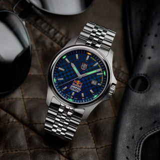 Silver watch with blue face on a textured surface - Red Bull Racing, 43 mm, Outdoor Watch - XL.2523.ARB.N